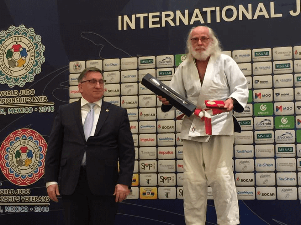 Andor receiving a Lifetime IJF Achievement Award in Miami at the IJF Veterans Championships in 2018 from Andrew Bondor, Manager of IJF Veterans Championships.