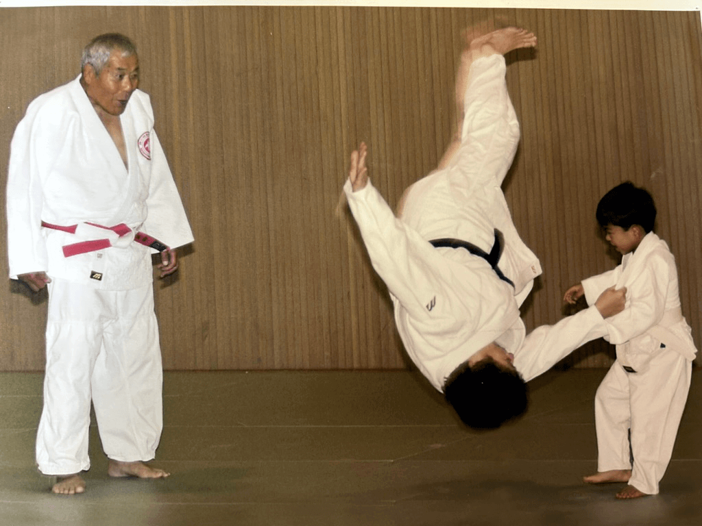 Dr. Ashida watching 4 year old grandson Alan throwing his mom